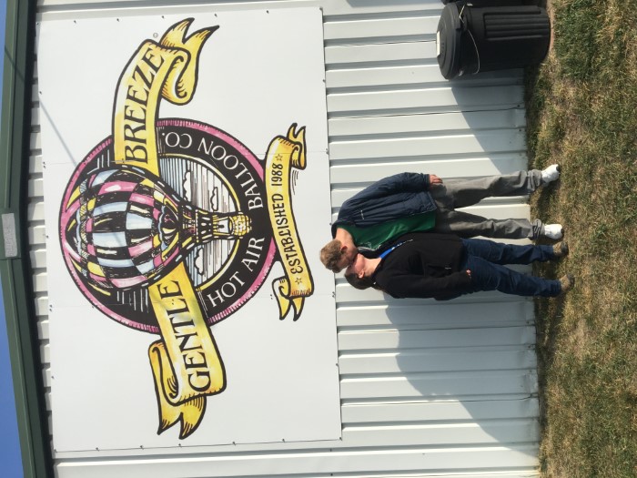 Wife and me underneath the Gentle Breeze Hot Air Balloon Co. logo.