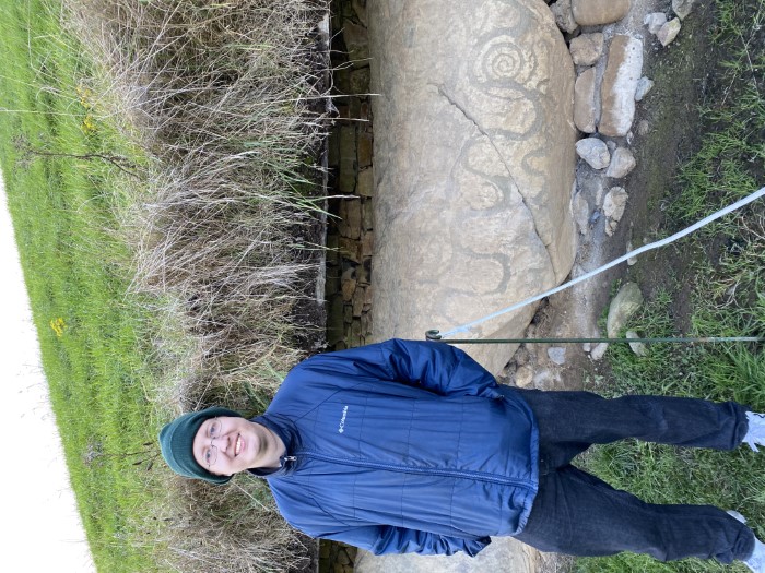 Me standing in front of one of the neolithic art at one of the Brú na Bóinne sites.