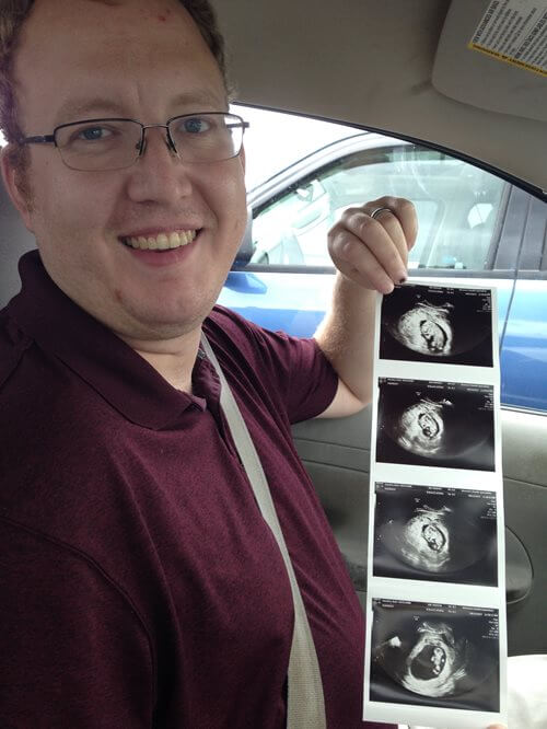 Me holding images of the first ultrasound.